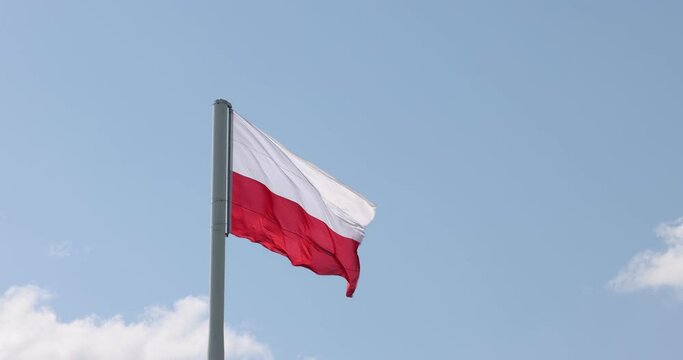 Polish flag on the mast. Beautiful Polish flag waving in a strong wind