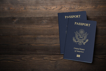 USA passport on dark brown wooden plank, citizenship by investment