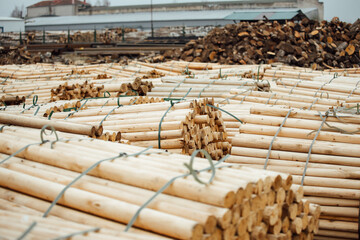 warehouse of a woodworking plant. the bundles of logs are stored and ready for transportation. a lot of processed smooth wooden bars