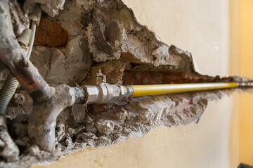 Construction site with new pipeline in brick wall. 
Pry open wall. Drywall.
Baustelle mit neuer...