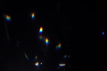 Blur colorful warm rainbow crystal light leaks on black background. Defocused abstract retro film...
