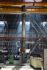Kazakhstan, Nur-sultan. Locomotive-building plant workshop scene view. Smoke of welding and ray of light.