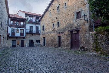 Fototapeta na wymiar Medieval and lonely street with cobbled floor in the famous and touristic town of Santillana del Mar, in the Cantabria region of Spain