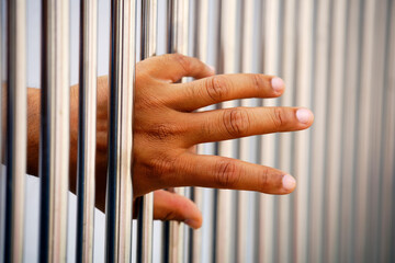 prisoner's hand arrest in jail bar