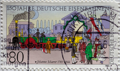 a postage stamp from Germany, showing the first journey of the historic Adler's train on the Ludwigseisenbahn. 150 years of the German railways and 200 years of Johannes Scharrer
