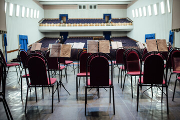 view of the empty concert hall from the stage. on the stage there are chairs and instruments for the musicians. preparation of the philharmonic for the performance of the famous orchestra