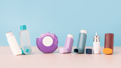 Set of asthma inhalers for asthma and COPD patients on table. Pharmaceutical product is used to treat lung inflammation and prevent asthma attack symptoms. Health care and medical concept. Copy space. - obrazy, fototapety, plakaty