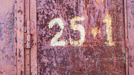 very old metal door with a hinge covered with rust