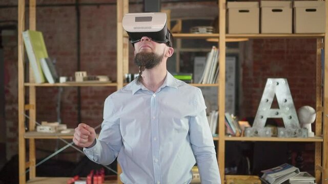 A guy European takes off his head virtual reality glasses