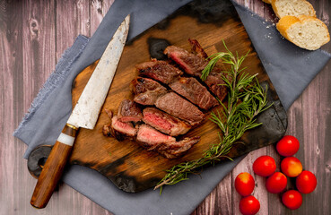 Churrasco of meat cut into pieces on a wooden board in a rustic setting. Aereal View - Landscape