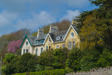 Fototapeta na wymiar Beautiful houses facades with gardens in Cobh, Ireland.