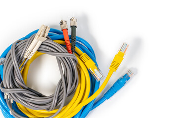 Group of ethernet network cables, rj45 network cable and fiber optic cables isolated on white...