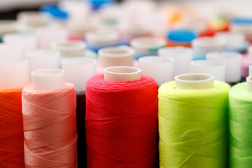 Close up of colored thread coils, thread spools background