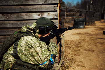 a laser tag game on the training ground. military tactical training with laser weapons. players in military uniforms run around the training ground playing war