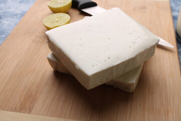 paneer making recipe ingredients, milk and lemon with fresh cottage cheese.