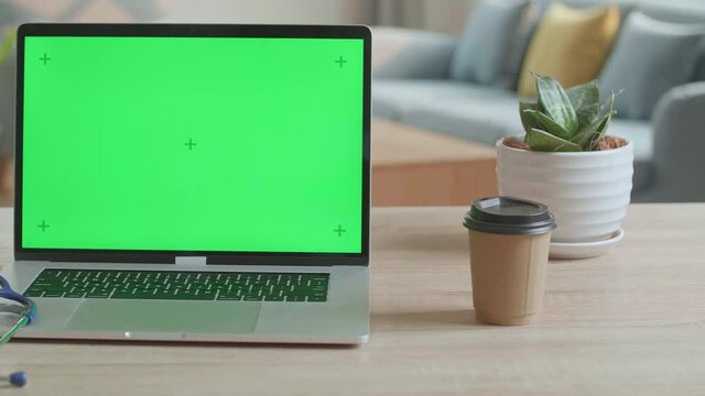 Dotor'S Computer Laptop With Green Screen On The Table
