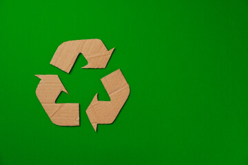 Paper recycling concept on green background top view
