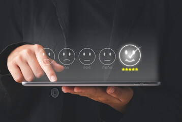 Satisfaction survey concept. Customer service evaluation Business people or customers show satisfaction through the application on the tablet screen. Giving the most satisfaction rating and 5 stars.