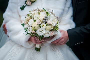 Bouquet of flowers in the hand of the bride