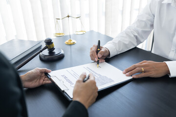 law,libra scale and hammer on the table, 2 men are dealing and signing contract, law matters...
