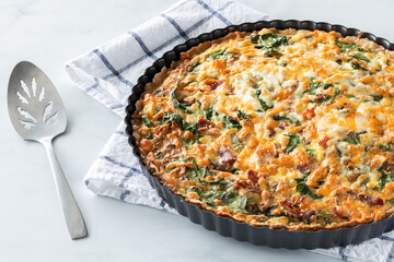 Close up view of a quiche fresh out of the oven ready for serving.