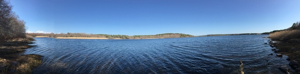 Panoramic shot of a quiet reservoir on a peaceful, sunny spring day