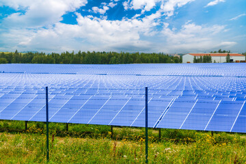 Farm with solar electric panels on a green field