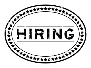 Grunge black hiring word oval rubber seal stamp on white background