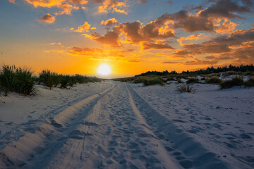 Fototapeta na wymiar sunset over beach tracks