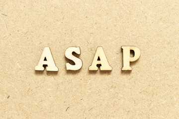 Alphabet letter in word ASAP (Abbreviation of as soon as possible) on wood background