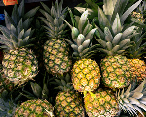 large batch of sweet and ripe pineapples for sale in public market
