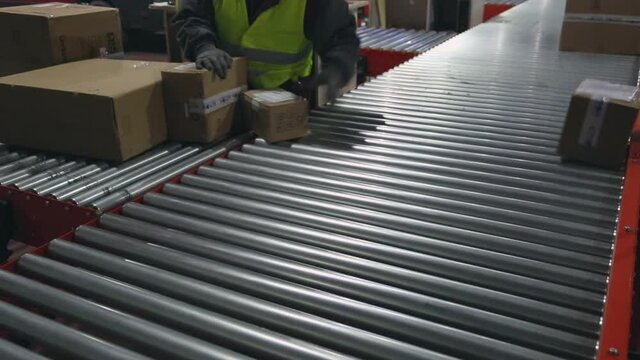 Scanning Packages Boxes at Conveyer Belt Postal Depot Service Shipping