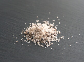 Salt with dried olive, seasoning mix, on grey background