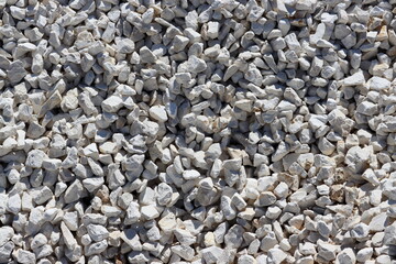 Small white and beige stones close-up. Stone texture and background