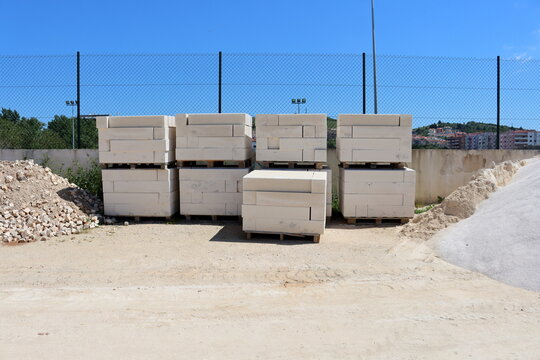 Aerated concrete blocks on pallets at the construction site.