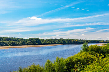 summer landscape with river and blue sky with clouds