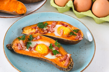 Baked sweet potato with fried egg, bacon and parsley.