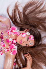 Obraz na płótnie Canvas Woman with body paint artwork and flowers