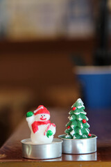 The handmade candles in the shape of snowmen and tree.