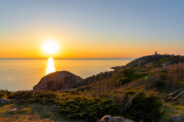 Sunset over sea at Kullaberg Peninsula (Nature reserve) in Sweden. Popular tourist destination for hiking. Selective focus.