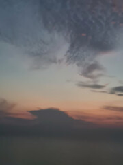 Abstract blurred of the Dark morning sky, dark sky, among the grey and blue clouds, use as a nature background, defocused style. Vertical image.