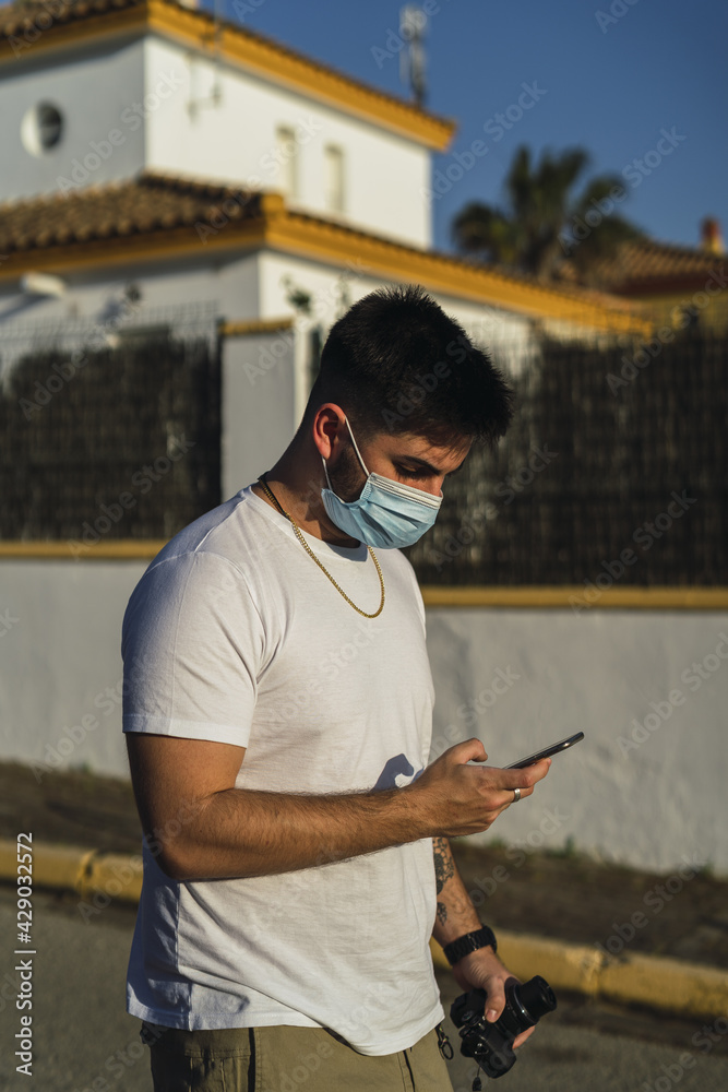 Sticker Vertical shot of a white Caucasian man staring at his phone