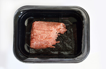 Minced pork in plastic container against white background