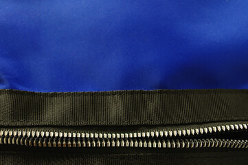 Black and blue textile texture background with silver color zipper