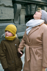 grandmother with little boy holding hands