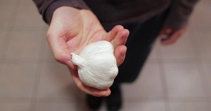 Holding a piece of garlic in hand