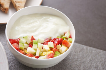 Bowl of healthy fresh fruit salad. fresh fruit and vegetable salad, healthy breakfast. bowl of oat granola with yogurt.