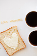 sandwich for breakfast in form of heart with cheese - good morning sign and two coffee cups