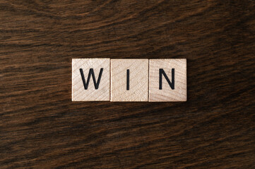 Wood Tiles Spelling "Win" on Wood Background