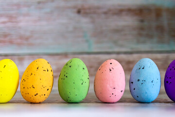 Easter eggs decorations over rustic colorful background. Colorful easter eggs on turquoise rustic wooden table. Easter, holidays, tradition, advertisement and object concept. Copy space.